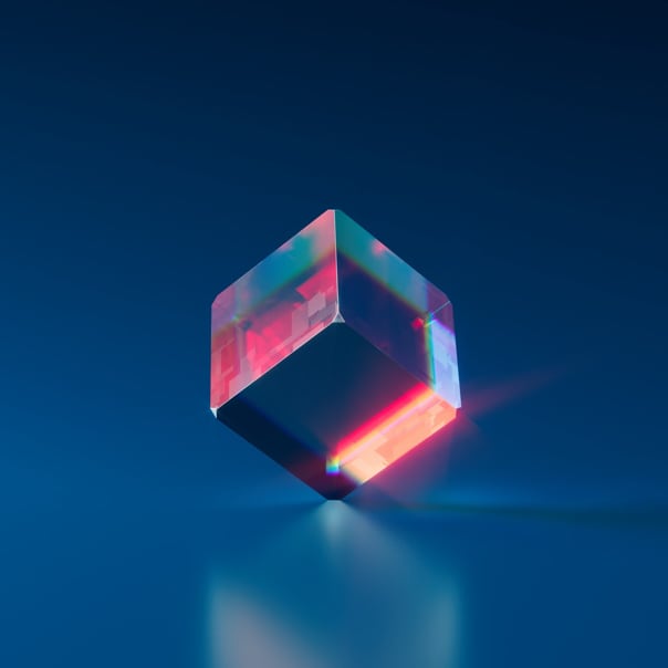 A cube standing on one corner, resting on a glass like surface